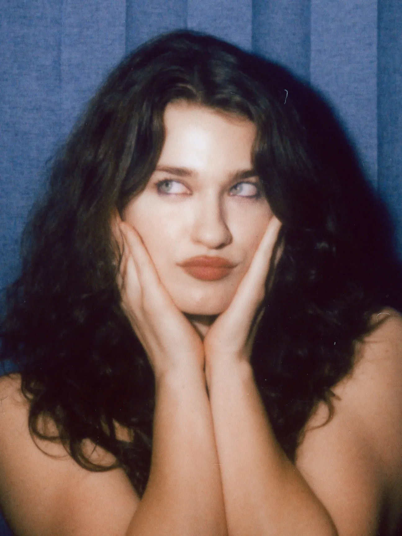 Enclosed photo booth color strip, frame one: hands on cheeks, eyes to the side