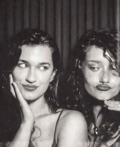 Film photo booth strip frame one: a hand on the chin and a sideways glance