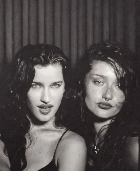 Film photo booth strip frame three: two friends looking straight into the camera